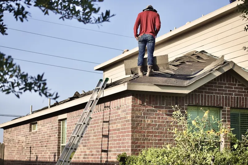 Professional roofer working on a residential roof in Forestville
